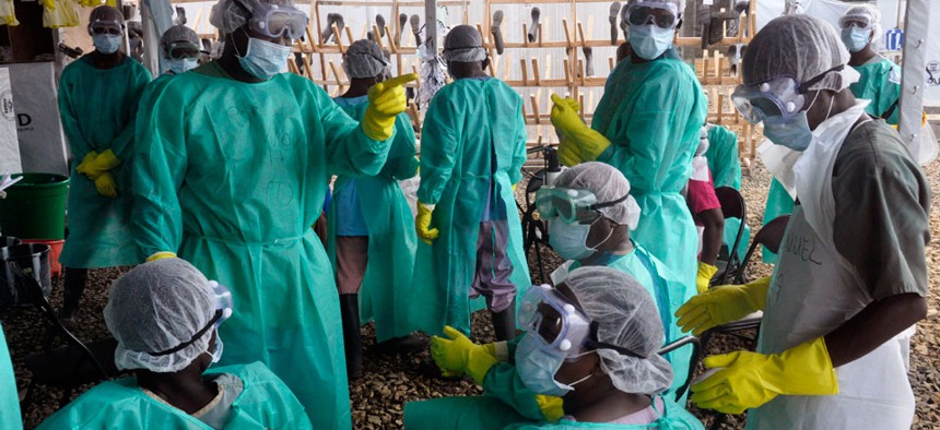 Health care workers inside a USAID, funded Ebola clinic with their Ebola virus protective gear in Monrovia, Liberia.