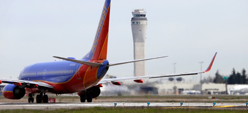 A Southwest airlines jet waiting to depart in view of the air traffic control tower at Seattle-Tacoma International Airport.
