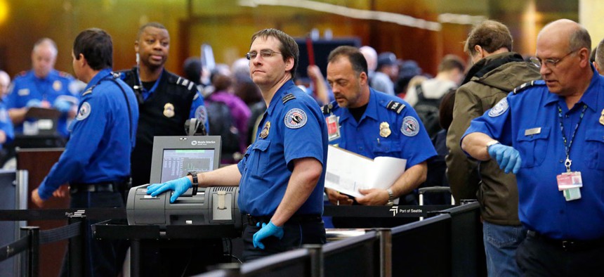 TSA agents work at a security check-point at Seattle-Tacoma International Airport in SeaTac, Wash.