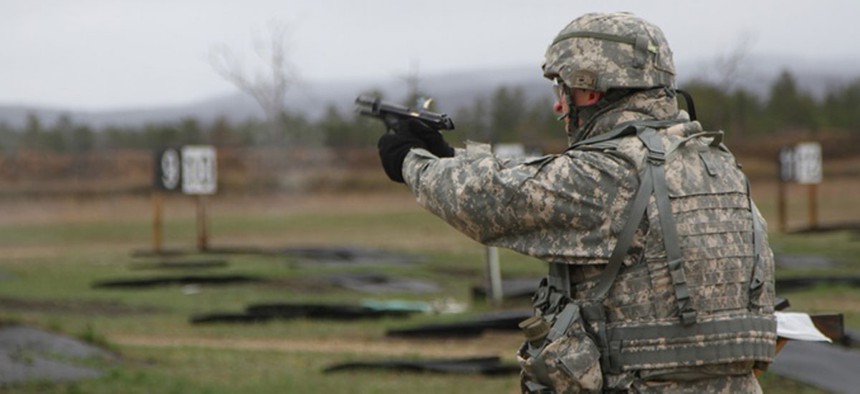 A specialist with the 533rd Brigade Support Battalion competes in a 9mm pistol course at the Best Warrior Competition at Fort McCoy, Wisc., on April 29, 2014.