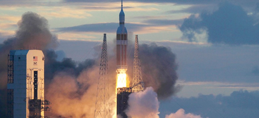 A NASA Orion capsule on top of a Delta IV rocket lifts off on its first unmanned orbital test flight from Complex 37 B at the Cape Canaveral Air Force Station, Friday, Dec. 5, 2014