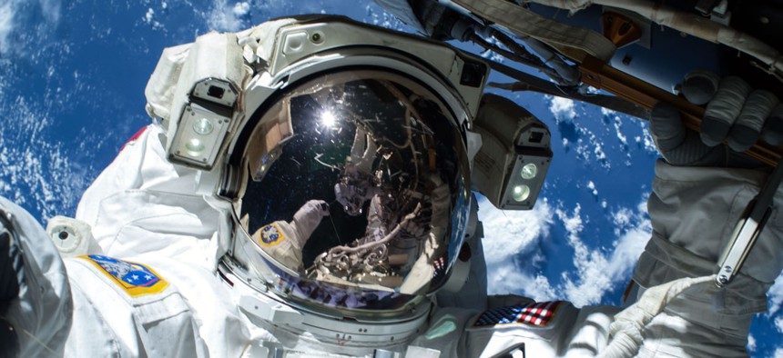 NASA astronaut Barry Wilmore works outside the International Space Station on the first of three spacewalks preparing the station for future arrivals by U.S. commercial crew spacecraft, Saturday, Feb. 21, 2015.