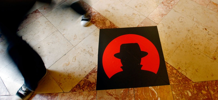 A man passes a logo of the Black Hat technology conference in Las Vegas.