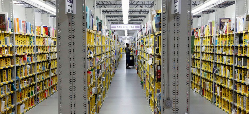 An Amazon.com employee stocks books at the Amazon.com Fulfillment Center in Phoenix. 