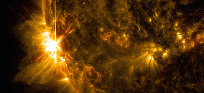 A solar flare bursts off the left limb of the sun in this image captured by NASA's Solar Dynamics Observatory on June 10, 2014.