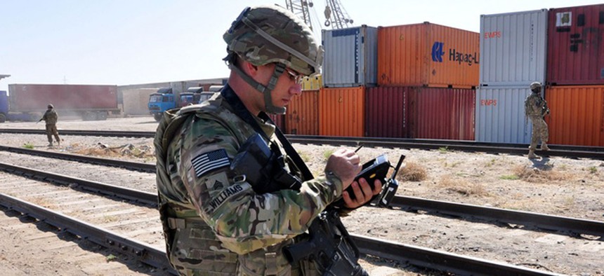 An Army soldier uses a handheld portable deployment kit to scan for U.S. cargo at a northern Afghanistan port, on Sept. 21, 2012.