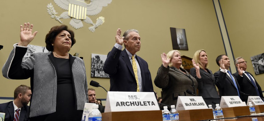 OPM Director Katherine Archuleta, left, and others, are sworn in on Capitol Hill in Washington, Wednesday, June 24, 2015, prior to testifying before the House Oversight and Government Reform Committee hearing on recent cyber attacks. From left are, Archul