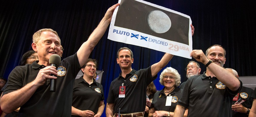 New Horizons crew members celebrate at the Johns Hopkins University Applied Physics Laboratory (APL) in Laurel, Md.