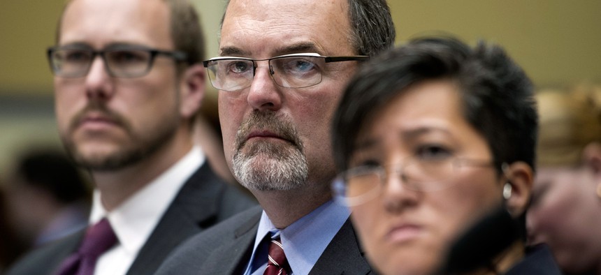 Federal CIO Tony Scott, center, and Sylvia Burns, Interior Department CIO, right, testify before Congress.