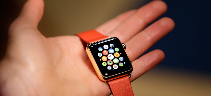 A woman holds the Apple Watch Edition during a demo following an Apple event Monday, March 9, 2015, in San Francisco. 
