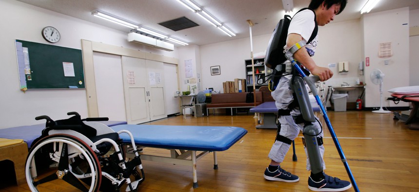Yuichi Imahata walks using a robotic exoskeleton called ReWalk at Kanagawa Rehabilitation Center in Atgugi, west of Tokyo. Imahata, 31, has been using a wheelchair to get around for seven years after a serious spinal-cord injury.