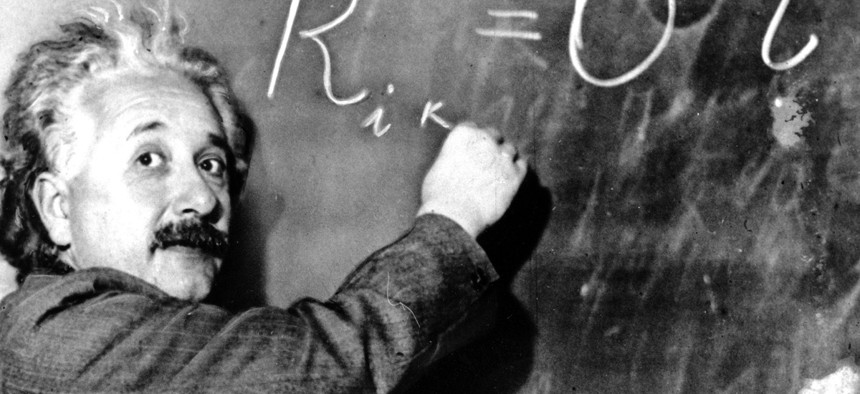 Dr. Albert Einstein writes out an equation for the density of the Milky Way on the blackboard at the Carnegie Institute, Mt. Wilson Observatory headquarters in Pasadena, Calif.