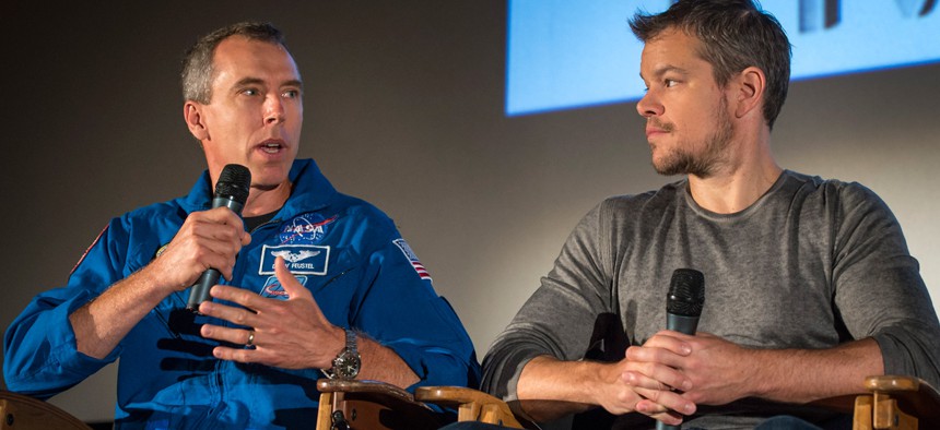 Astronaut Drew Feustel, left, speaks as actor Matt Damon listens during a question and answer session about NASA’s journey to Mars and the film "The Martian."