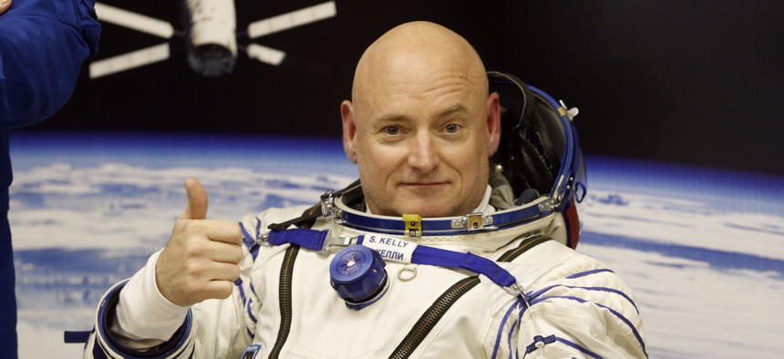 U.S. astronaut Scott Kelly, crew member of the mission to the International Space Station, ISS, gives a thumbs up prior the launch of a Soyuz-FG rocket.