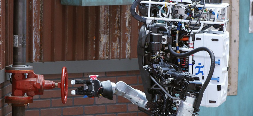 Robot Running Man from the Florida Institute for Human and Machine Cognition proceeds to turn a valve in the U.S. Defense Advanced Research Projects Agency Robotics Challenge in Pomona, Calif.