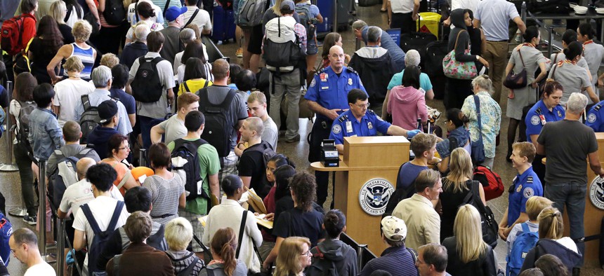 Aug. 11, 2015, at Seattle-Tacoma International Airport, TSA agents are surrounded by travelers in lines that snake around the airport.