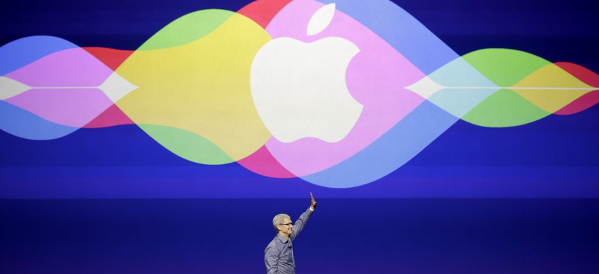 Apple CEO Tim Cook waves during the Apple event In San Francisco, Sept. 9, 2015. 