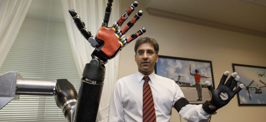 Kapil D. Katyal, an engineer at Johns Hopkins, demonstrates a robotic hand as DARPA displays the latest high-tech projects being developed for wounded soldiers at the Pentagon.