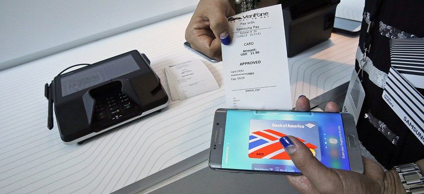 A product expert demonstrates the Samsung Pay during a presentation, Thursday, Aug. 13, 2015, at Lincoln Center in New York.