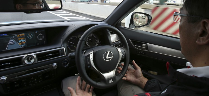 An employee of Toyota Motor Corp., drives automated driving test vehicle during a test drive.