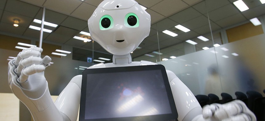 SoftBank Corp.'s new companion robot Pepper performs during an interview.