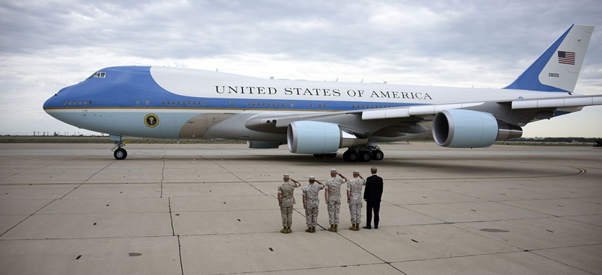 Marines salute as President Barack Obama leaves in Air Force One from Marine Corps Air Station Miramar in San Diego.