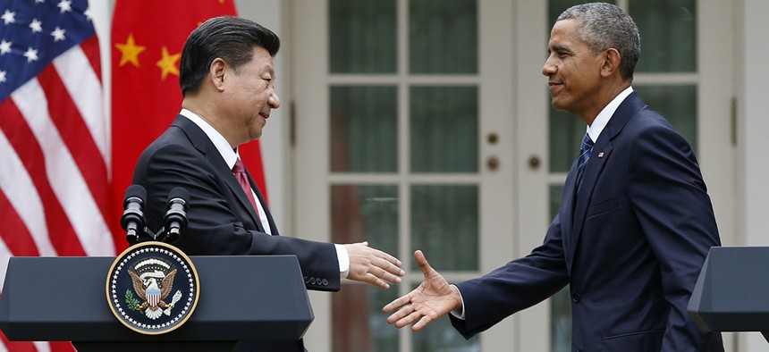 President Barack Obama shakes hands with Chinese President Xi Jinping .