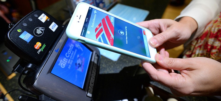 A customer uses Apple Pay at a Disney Store.