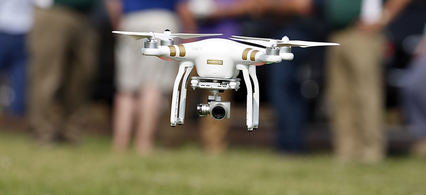A DJI Phantom 3 drone is flown during a drone demonstration at a farm.