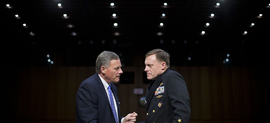 Senate Intelligence Committee Chairman Richard Burr talks with National Security Agency Director Adm. Michael Rogers on Capitol Hill on Sept. 24.