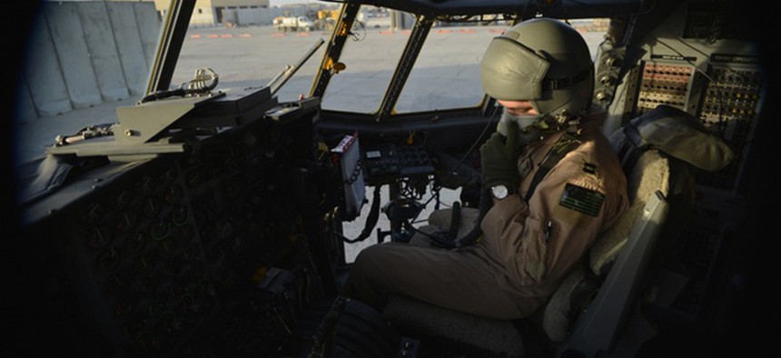 U.S. Air Force Capt. Frank Von Heiland, 41st Expeditionary Electronic Combat Squadron co-pilot, checks his oxygen mask on an EC-130H Compass Call aircraft at Bagram Air Field, Afghanistan, Sept. 12, 2014.