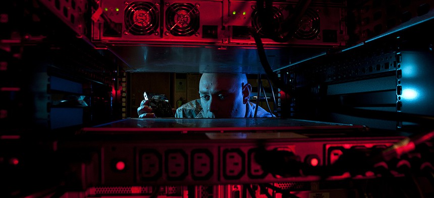 U.S. Air Force Staff Sgt. Jerome Duhan, a network administrator with the 97th Communications Squadron, inserts a hard drive into the network control center retina server at Altus Air Force Base, Okla.