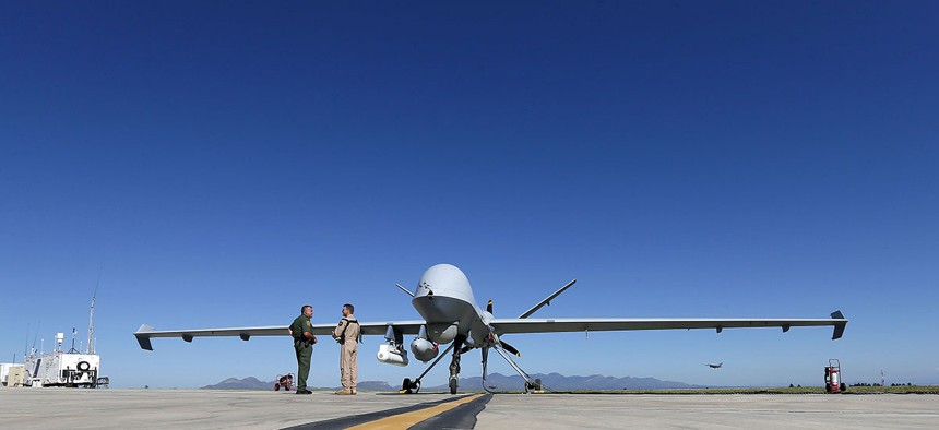 Lothar Eckardt, right, executive director of National Air Security Operations at U.S. Customs and Border Protection, speaks with a Customs and Border Patrol agent prior to a drone aircraft flight.