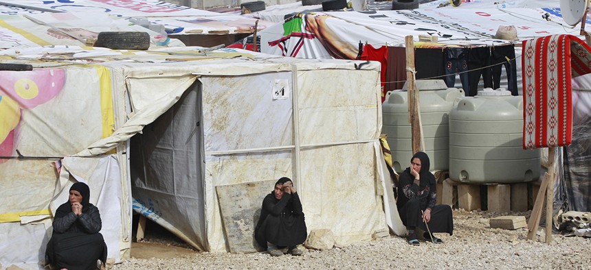 Syrian refugees women sitting outside their tents, during the visit of Filippo Grandi, the United Nations High Commissioner for Refugees, UNHCR, to a camp in the town of Saadnayel, in the Bekaa valley, Lebanon, Friday, Jan. 22, 2016.