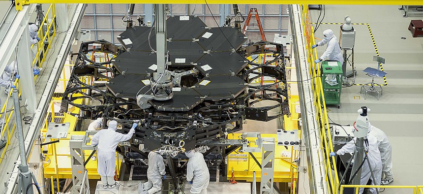 Inside NASA's Goddard Space Flight Center's massive clean room in Greenbelt, Maryland, the ninth flight mirror was installed onto the telescope structure with a robotic arm. 