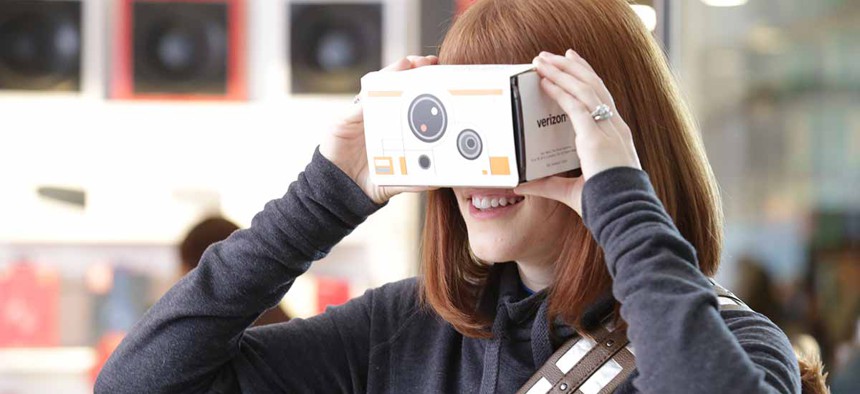 A customer tries out one of Star Wars Google Cardboard Virtual Reality viewers 