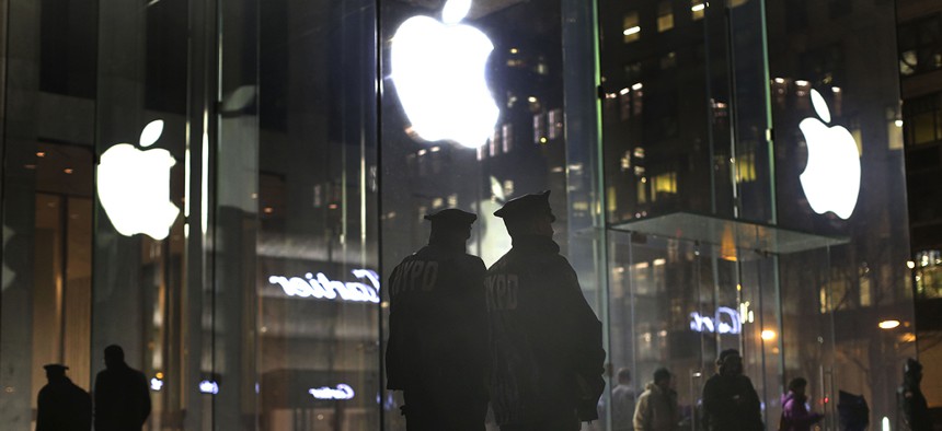 NYPD officers stand outside the Apple Store to monitor a demonstration. Protesters assembled in more than 30 cities around the world to lash out at the FBI for obtaining a court order to require Apple to make it easier to unlock an iPhone.