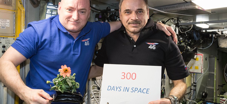 One-year mission crew members Scott Kelly of NASA, left, and Mikhail Kornienko of Roscosmos celebrate their 300th consecutive day in space.