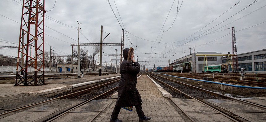 A local woman walks along a rail-road crossing in Debaltseve, eastern Ukraine.