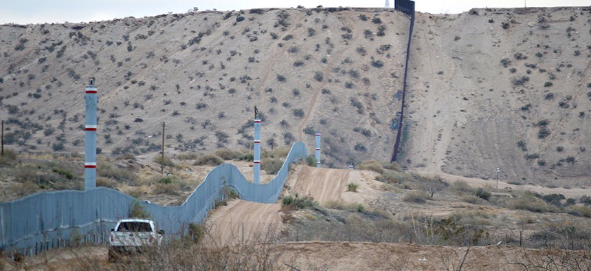 A U.S. Border Patrol agent drives near the U.S.-Mexico border fence in Sunland Park, N.M.