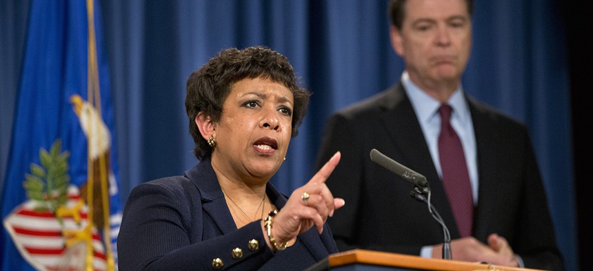 Attorney General Loretta Lynch, accompanied by FBI Director James Comey, speaks during a news conference to discuss seven hackers tied to the Iranian government that were charged Thursday.