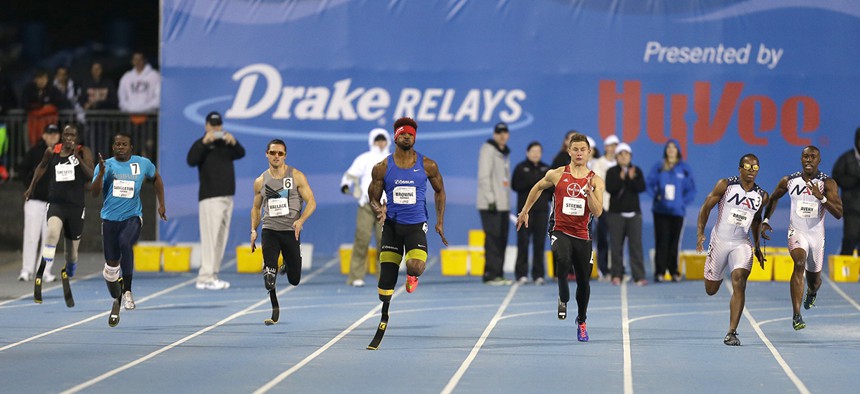 Richard Browne, center, leads the field to the finish line in the men's paralympic 200-meter dash at the Drake Relays athletics meet, Friday, April 24, 2015.