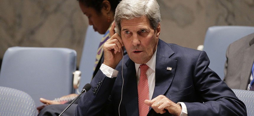 U.S. Secretary of State John Kerry, adjusts his translation ear piece during a U.N. Security Council meeting.
