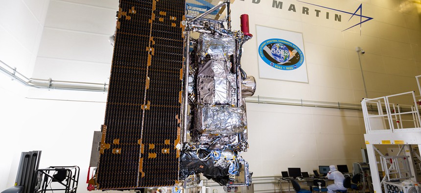 The fully assembled GOES-R satellite with its solar array stowed, in a clean room at Lockheed Martin.