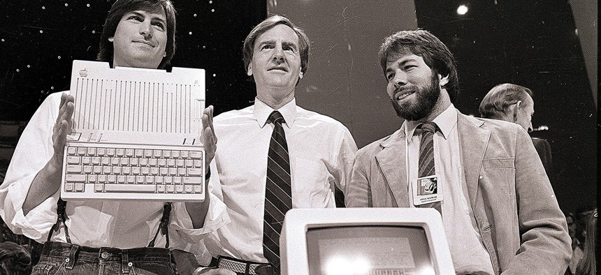 Steve Jobs, left, chairman of Apple Computers, John Sculley, center, president and CEO, and Steve Wozniak, co-founder of Apple, unveil the new Apple IIc computer in San Francisco in 1984.