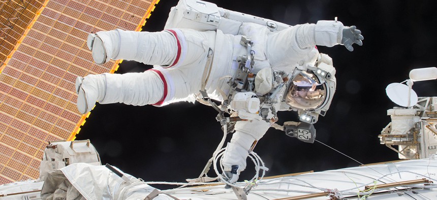 Expedition 46 Commander Scott Kelly participates in a spacewalk outside the ISS in which he and Flight Engineer Tim Kopra, not pictured, moved the station's mobile transporter rail car ahead of the docking of a Russian cargo supply spacecraft.