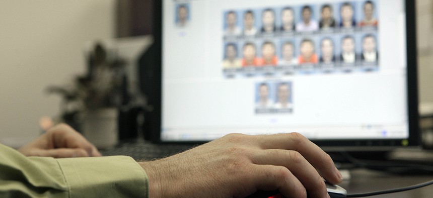 Stephen Lamm, supervisor with the ID Fraud Unit of the North Carolina Department of Motor Vehicles looks through photos in the facial recognition system.