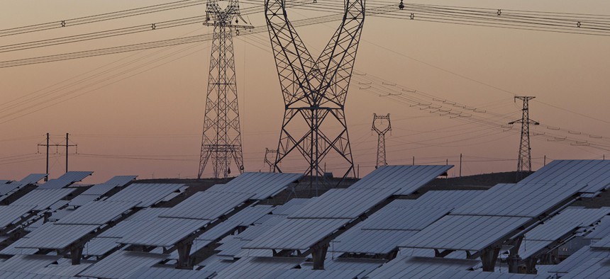 Solar panels are seen near the power grid in northwestern China's Ningxia Hui autonomous region. 