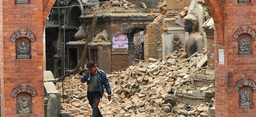 A Nepalese man cries as he walks through the earthquake debris in Bhaktapur, near Kathmandu, Nepal. The violence of the 7.8-magnitude earthquake left countless towns and villages across central Nepal in a shambles.