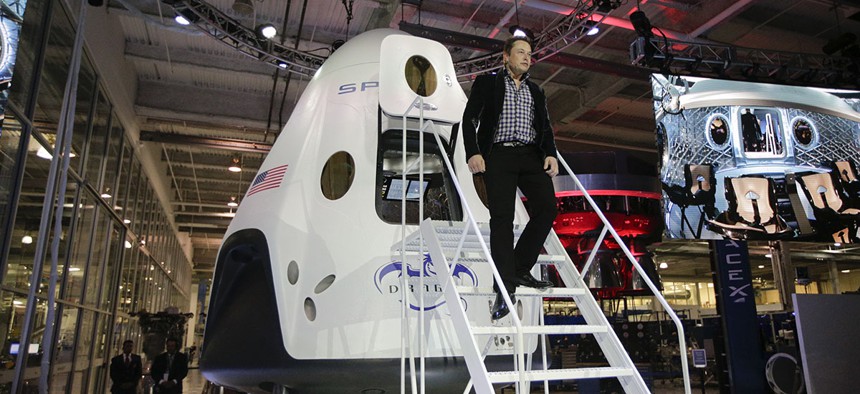 Elon Musk, CEO and CTO of SpaceX, walks down the steps while introducing the SpaceX Dragon V2 spaceship at the company headquarters.